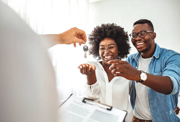 Young couple in love starting family life, got a chance of acquiring independent home ownership, given key from new apartment, social renting, purchasing new apartment, meeting with real estate agent